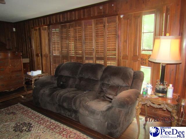 living room with wood walls