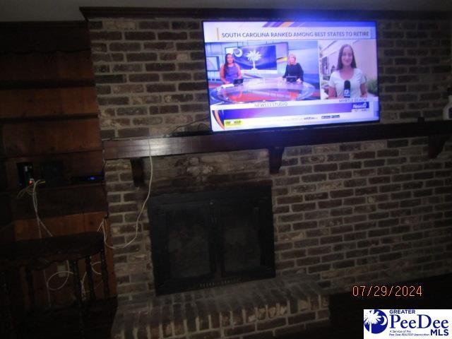 interior details featuring a brick fireplace