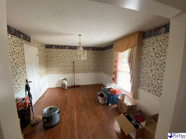 dining area with hardwood / wood-style floors and a textured ceiling