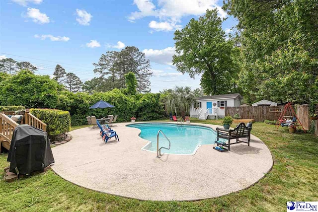 view of swimming pool with a lawn, a patio, a fenced in pool, and a fenced backyard