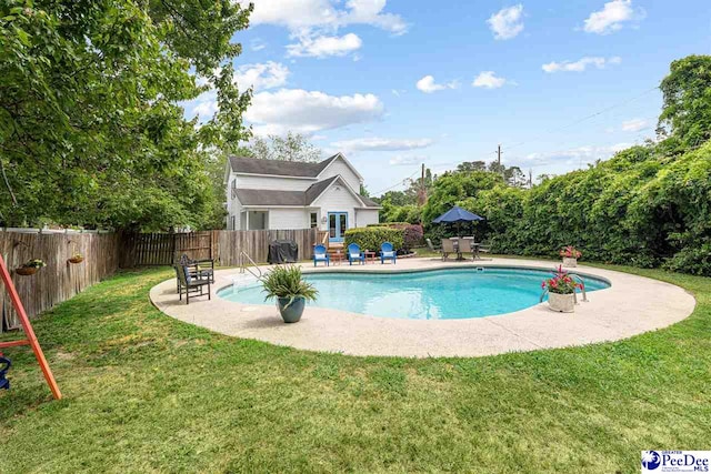 view of swimming pool with a lawn, a fenced backyard, a fenced in pool, and a patio