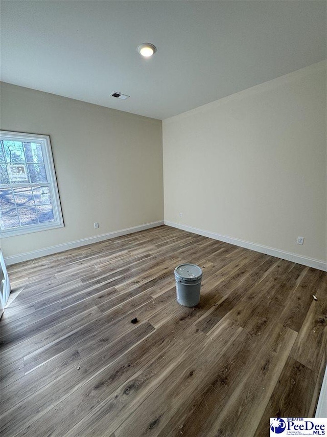 empty room featuring hardwood / wood-style flooring