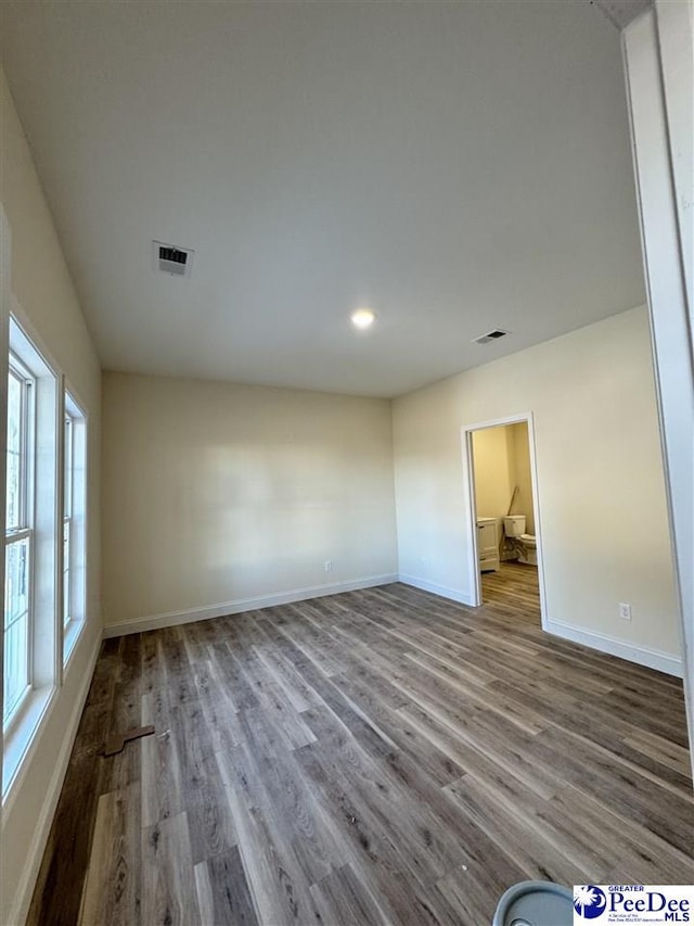 unfurnished room with hardwood / wood-style flooring