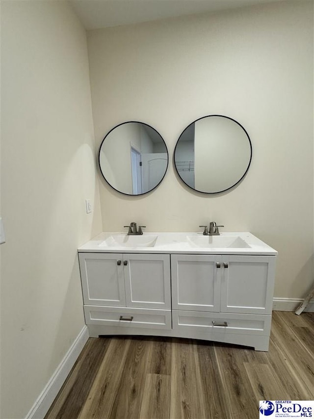 bathroom featuring vanity and hardwood / wood-style floors