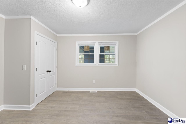 616 Sandra Ter, Florence, SC 29501 - spare room featuring crown molding, baseboards, a textured ceiling, and wood finished floors