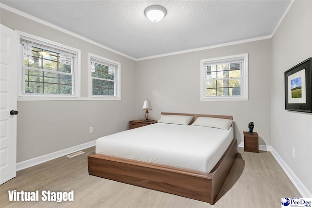 616 Sandra Ter, Florence, SC 29501 - bedroom featuring a textured ceiling, baseboards, and wood finished floors