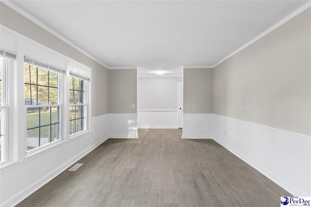 616 Sandra Ter, Florence, SC 29501 - empty room featuring wood finished floors, crown molding, baseboards, and visible vents
