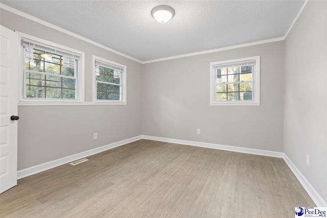616 Sandra Ter, Florence, SC 29501 - empty room with baseboards, a textured ceiling, crown molding, and light wood finished floors