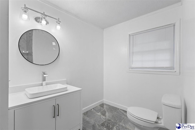616 Sandra Ter, Florence, SC 29501 - bathroom with toilet, vanity, and baseboards