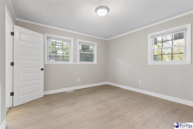 616 Sandra Ter, Florence, SC 29501 - unfurnished bedroom with light wood finished floors, visible vents, crown molding, and a textured ceiling