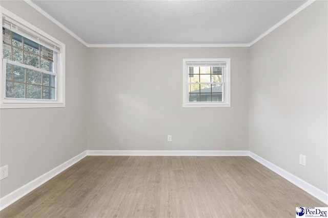 616 Sandra Ter, Florence, SC 29501 - unfurnished room with crown molding, a textured ceiling, baseboards, and wood finished floors