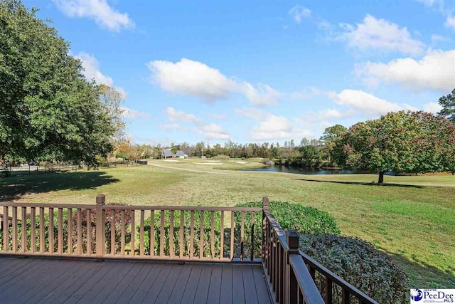 wooden deck with a yard and a water view