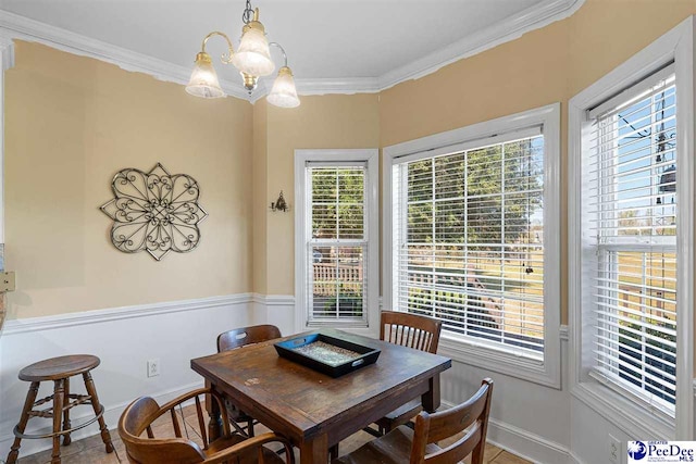 dining area featuring crown molding and a notable chandelier