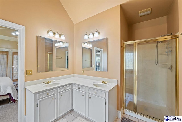 bathroom with lofted ceiling, a shower with shower door, tile patterned flooring, and vanity