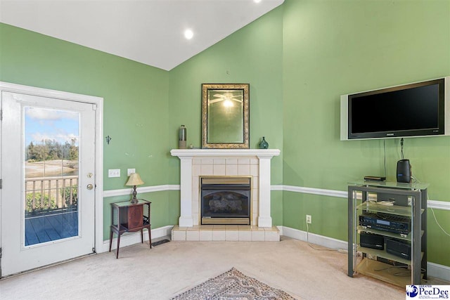 carpeted living room with lofted ceiling and a fireplace