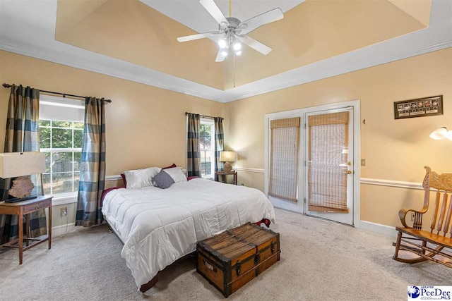 bedroom with crown molding, carpet, ceiling fan, and a tray ceiling