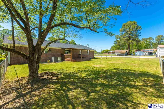 616 Forest Acres Dr, Pamplico, SC 29505 - view of yard featuring central AC, fence, and a deck