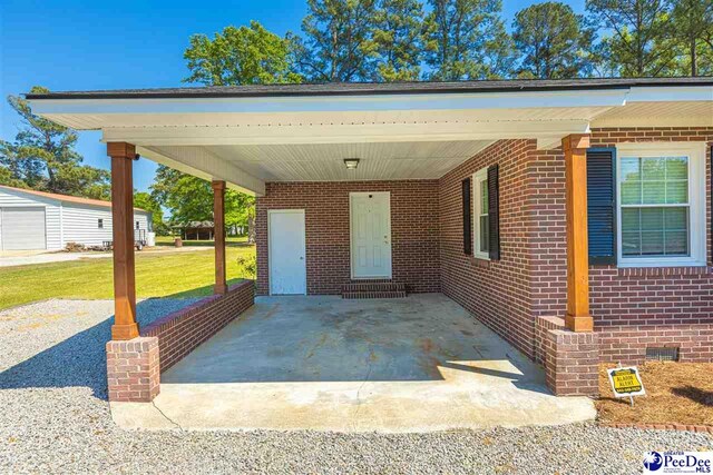 616 Forest Acres Dr, Pamplico, SC 29505 - exterior space featuring brick siding, a front lawn, and an attached carport