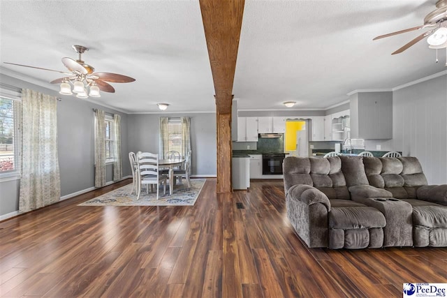 616 Forest Acres Dr, Pamplico, SC 29505 - living area with dark wood-type flooring, a textured ceiling, a ceiling fan, and ornamental molding