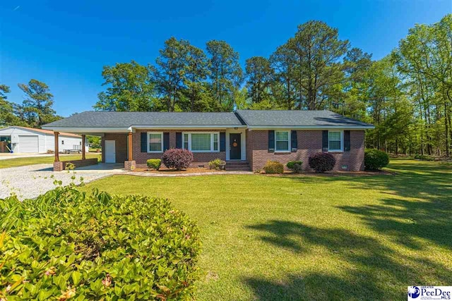 616 Forest Acres Dr, Pamplico, SC 29505 - ranch-style house featuring an outbuilding, gravel driveway, a front lawn, brick siding, and an attached carport