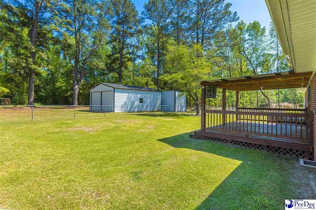 616 Forest Acres Dr, Pamplico, SC 29505 - view of yard with a storage shed, a garage, fence, an outbuilding, and a wooden deck