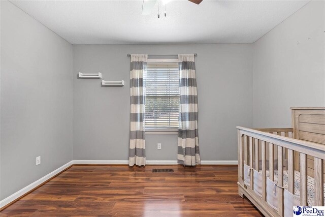 616 Forest Acres Dr, Pamplico, SC 29505 - unfurnished bedroom with visible vents, baseboards, a ceiling fan, and wood finished floors