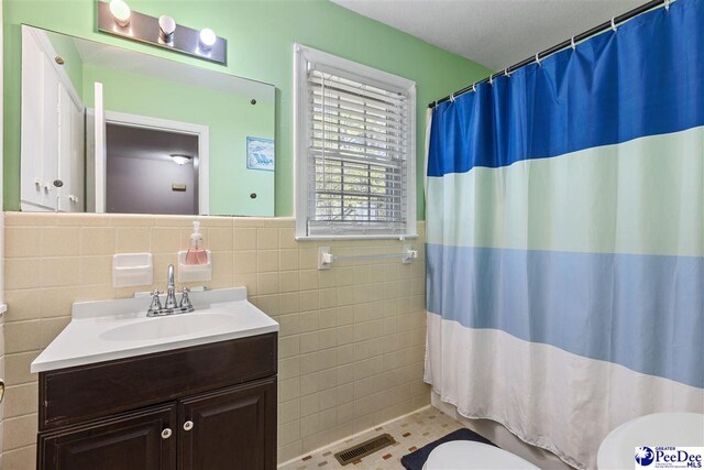 616 Forest Acres Dr, Pamplico, SC 29505 - bathroom with curtained shower, vanity, tile walls, and toilet