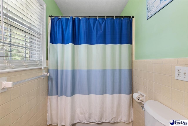 616 Forest Acres Dr, Pamplico, SC 29505 - bathroom with toilet, curtained shower, wainscoting, and tile walls