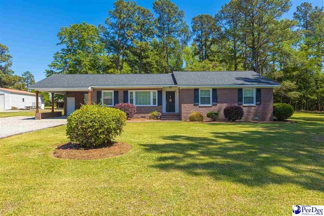 616 Forest Acres Dr, Pamplico, SC 29505 - single story home with gravel driveway, brick siding, a carport, and a front lawn