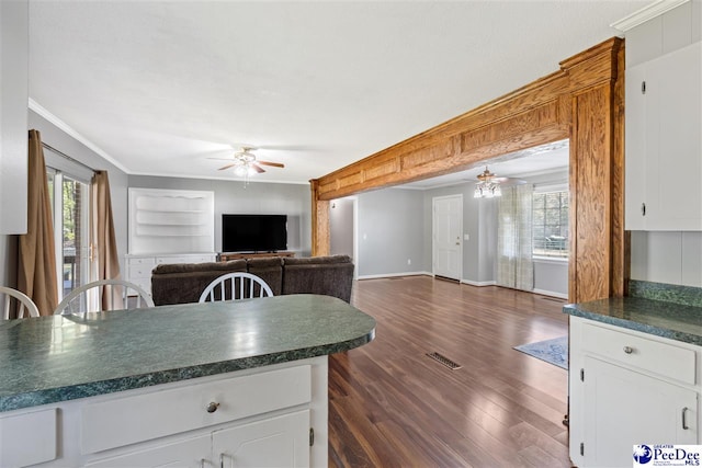 616 Forest Acres Dr, Pamplico, SC 29505 - kitchen featuring dark wood-style flooring, open floor plan, ceiling fan, dark countertops, and crown molding