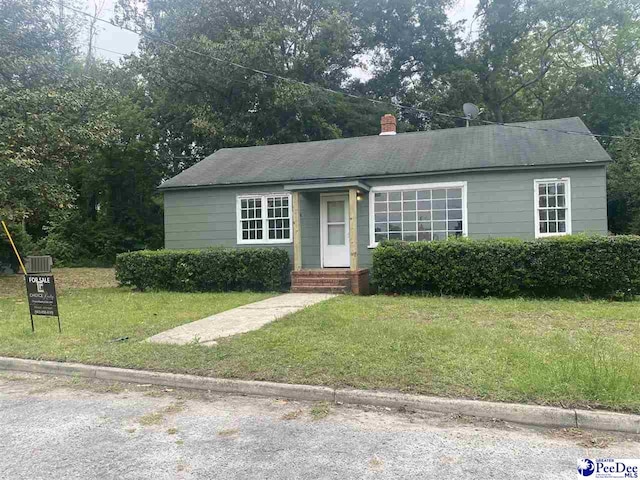 132 Wilson St, Darlington, SC 29532 - view of front of home featuring a front lawn, a chimney, central air condition unit, and entry steps