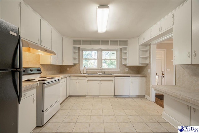 kitchen featuring white cabinetry, sink, white appliances, and tasteful backsplash