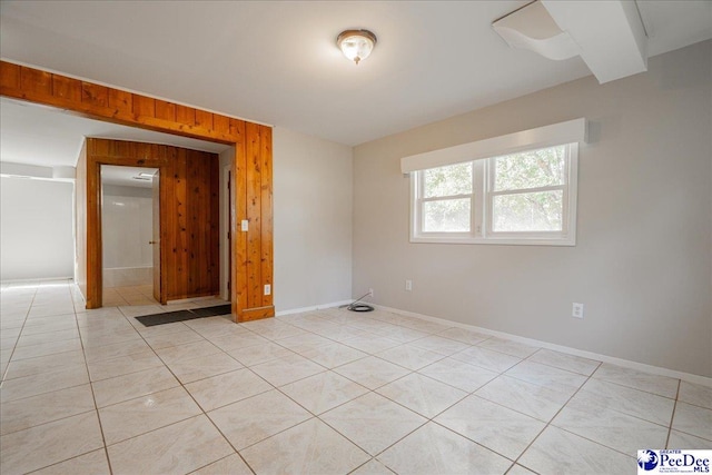 tiled empty room with wood walls