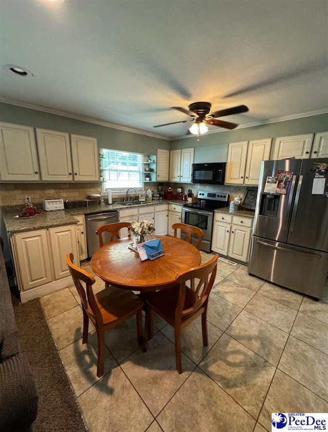 kitchen featuring tasteful backsplash, ornamental molding, stainless steel appliances, and sink