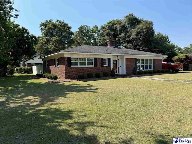 ranch-style home with a front lawn