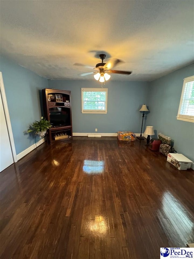 miscellaneous room featuring dark wood-type flooring and ceiling fan