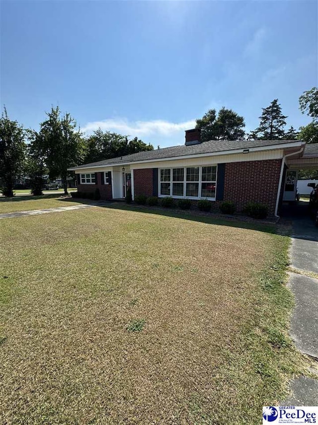 single story home with a front lawn and a carport