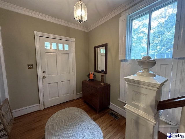 foyer entrance with crown molding and dark hardwood / wood-style floors