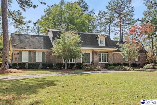 new england style home with a front yard