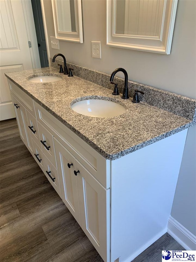 7423 E National Cemetery Rd, Florence, SC 29506 - full bathroom featuring double vanity and wood finished floors