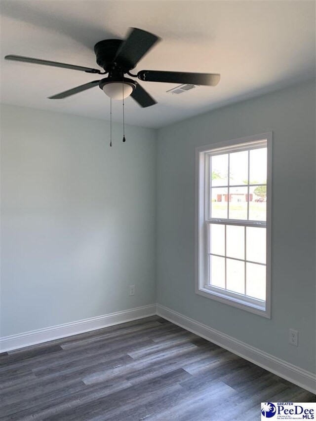 7423 E National Cemetery Rd, Florence, SC 29506 - unfurnished room with dark wood finished floors, baseboards, and a ceiling fan
