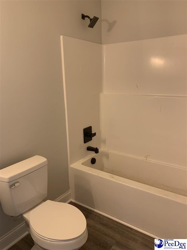 full bathroom with shower / washtub combination, wood finished floors, toilet, and baseboards