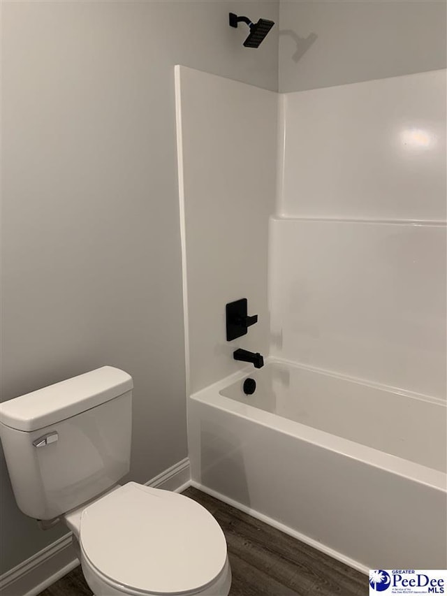 7423 E National Cemetery Rd, Florence, SC 29506 - full bathroom featuring toilet, baseboards, wood finished floors, and washtub / shower combination