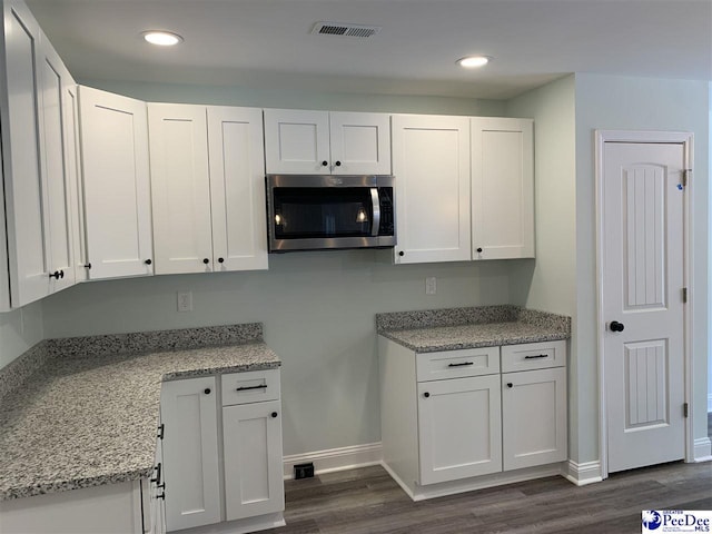 7423 E National Cemetery Rd, Florence, SC 29506 - kitchen with stainless steel microwave, white cabinets, dark wood-style floors, baseboards, and recessed lighting