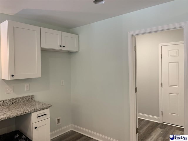 7423 E National Cemetery Rd, Florence, SC 29506 - kitchen with dark wood-type flooring, white cabinets, baseboards, and light stone countertops