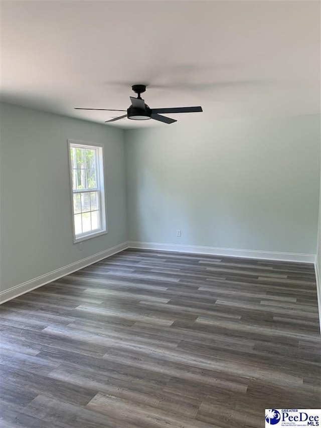 7423 E National Cemetery Rd, Florence, SC 29506 - unfurnished room with baseboards, a ceiling fan, and dark wood-style flooring