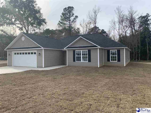 ranch-style home with a garage, concrete driveway, and a front yard