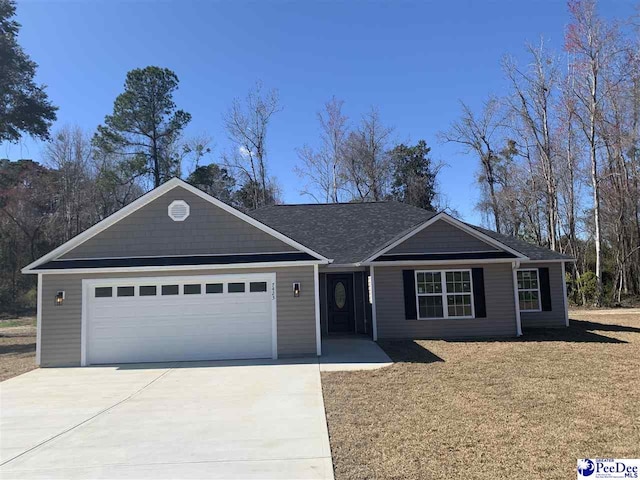 ranch-style home with an attached garage, concrete driveway, and a front lawn