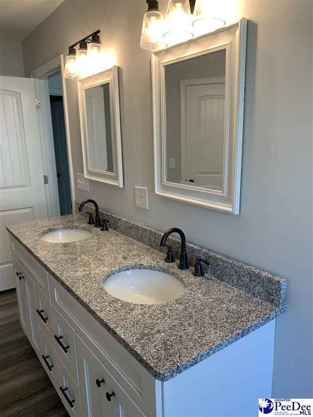 7423 E National Cemetery Rd, Florence, SC 29506 - bathroom featuring double vanity, a chandelier, and wood finished floors