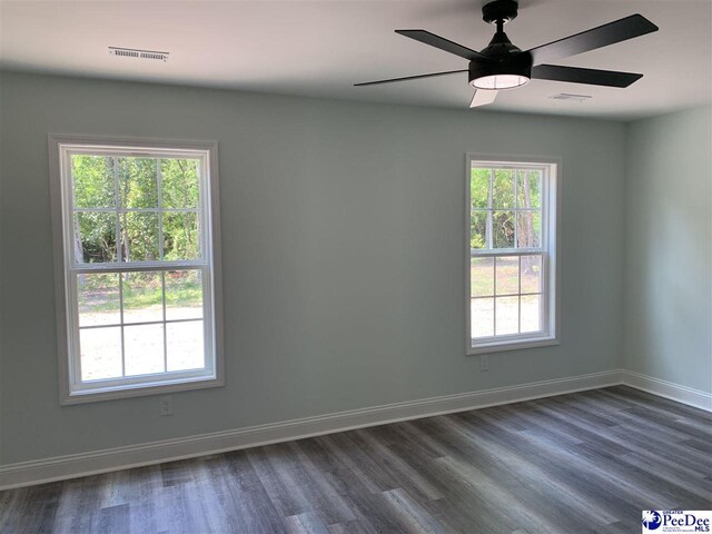 7423 E National Cemetery Rd, Florence, SC 29506 - spare room with dark wood-style floors, baseboards, and ceiling fan